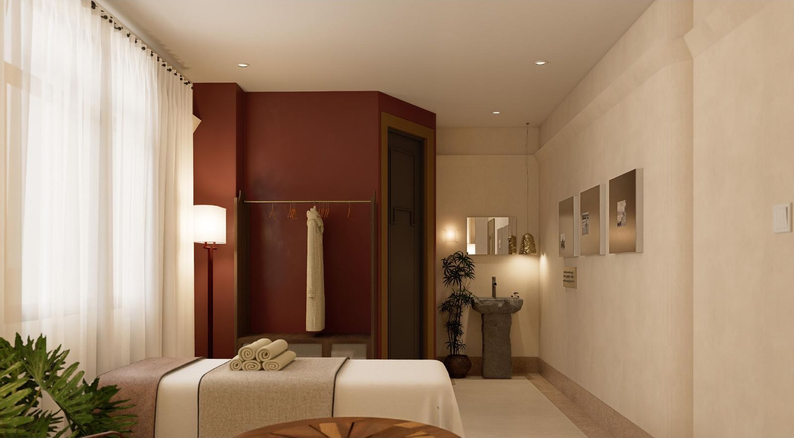 A treatment room with a massage bed and oxblood wall